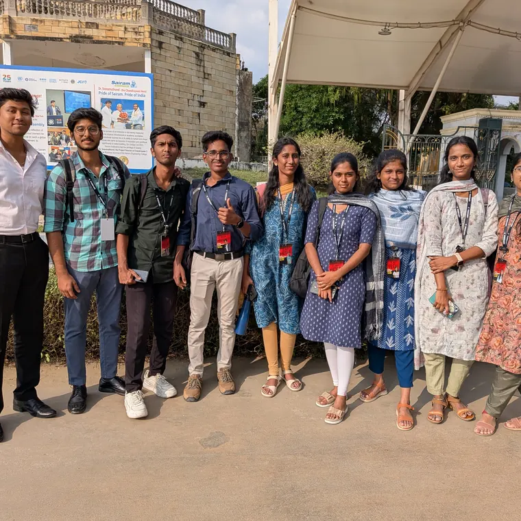 Group photo of event attendees standing outside a venue.