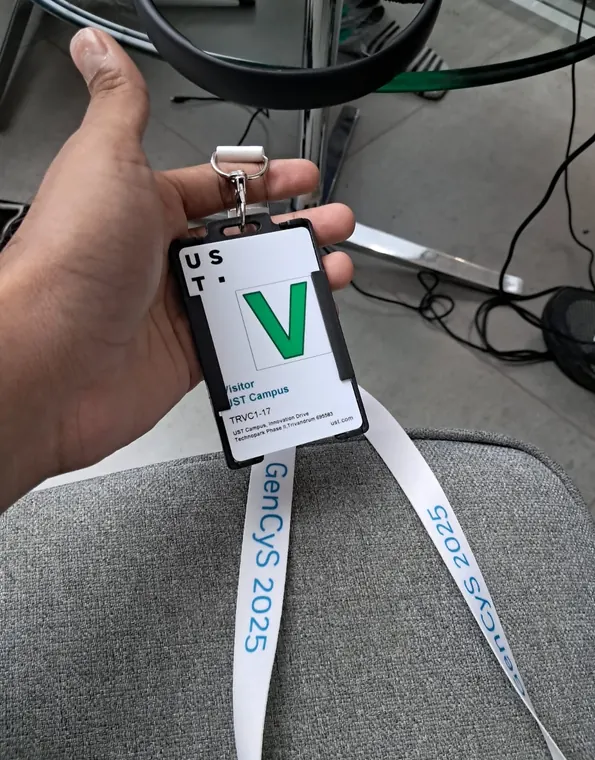 Close-up of an event badge and lanyard held in one hand.